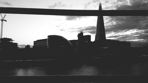 Buildings against cloudy sky at sunset