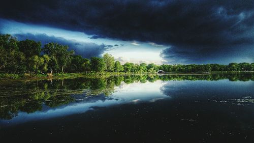 Scenic view of lake against cloudy sky