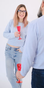 Portrait of smiling couple standing against white background