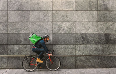 Man riding bicycle on wall