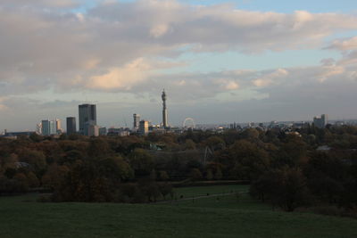 Scenic view of city against sky during sunset