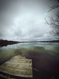 Pier over lake against sky