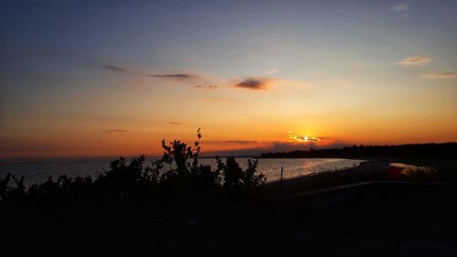 Scenic view of sea against orange sky