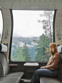 Side view of woman sitting in train
