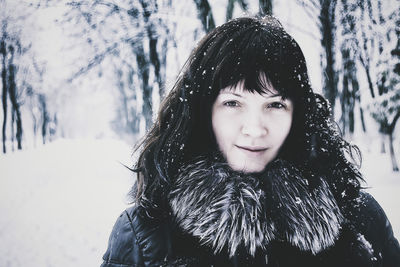 Portrait of beautiful woman during snow fall