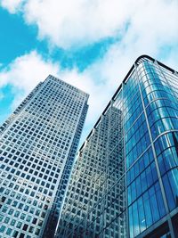 Low angle view of modern glass building against sky