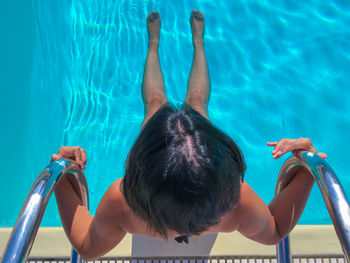 High angle view of boy swimming in pool