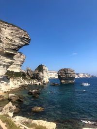 Scenic view of sea against clear blue sky