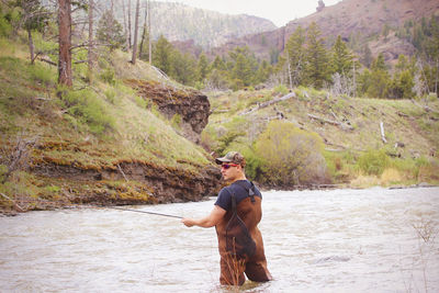 Full length of man standing on riverbank