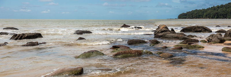 Rocks on beach against sky