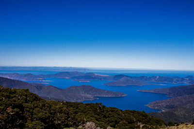 Scenic view of mountains against clear blue sky