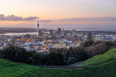 Aerial view of buildings in city during sunset