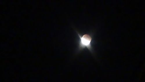 Low angle view of moon in the dark