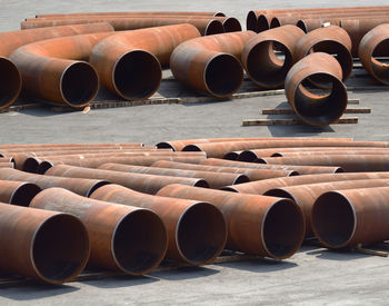Large rusty metallic pipes on road