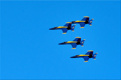 Low angle view of airshow against sky