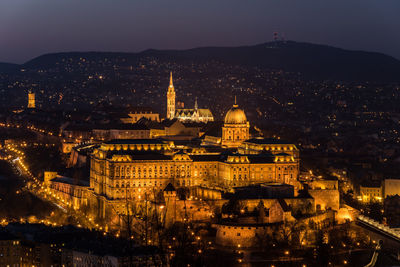 Aerial view of city lit up at night