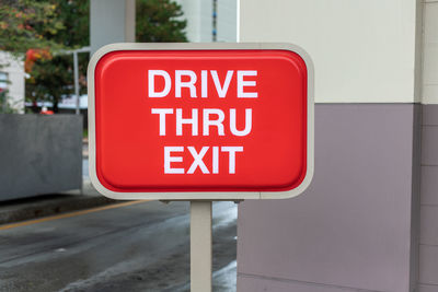 Drive thru exit red sign near fast food restaurant