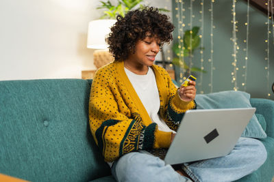 Young woman using laptop at home