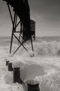 Lifeguard hut on beach against sky