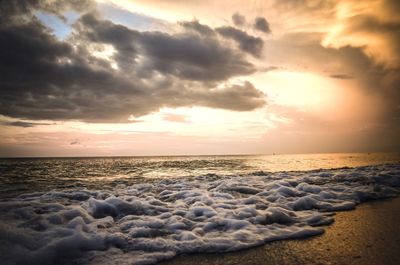 Scenic view of beach against sky during sunset