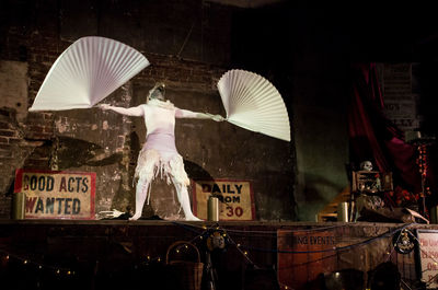 Man working on sculpture at night