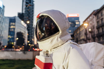 Male astronaut looking away during dusk