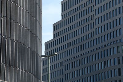 Low angle view of modern buildings in city against sky