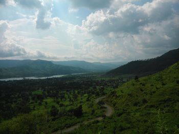 Scenic view of mountains against cloudy sky