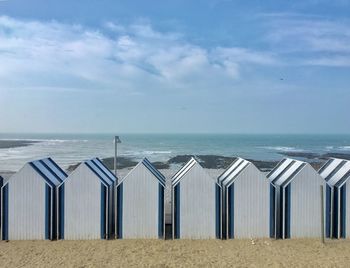 Scenic view of sea and beach huts 