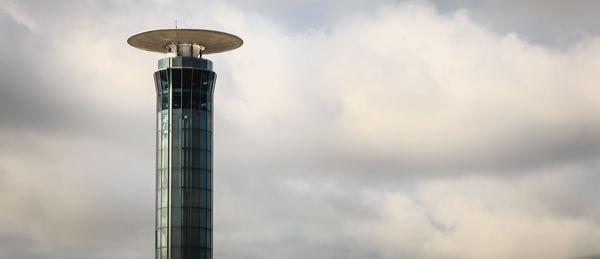 Low angle view of communications tower against sky