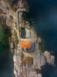 Aerial dron view of punta cabalo lighthouse in arousa island, spain. vertical photo