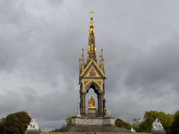 Low angle view of tower against cloudy sky