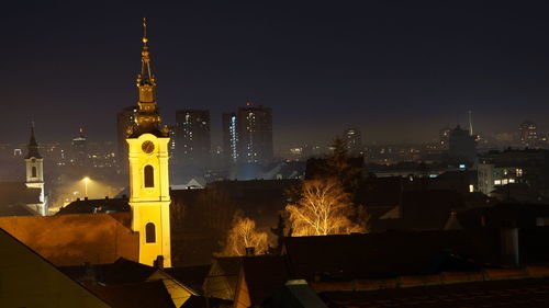 Illuminated buildings in city at night