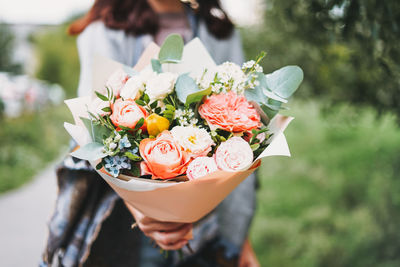 Young woman with bouquet of flowers 