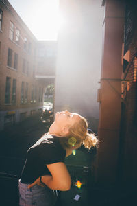 Woman leaning backward in city