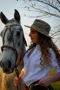 Photo session of a young girl dressed as a gaucho and her riding horse