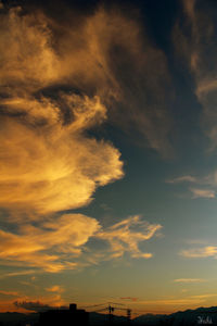 Silhouette of landscape against cloudy sky