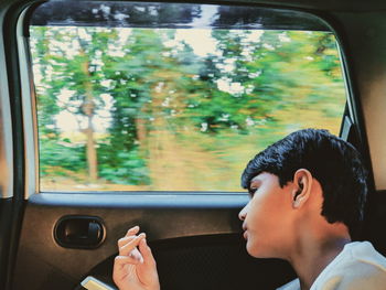 Portrait of man seen through car window