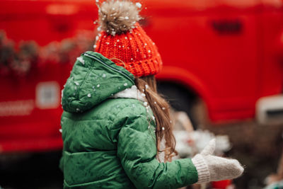 Rear view of woman holding car