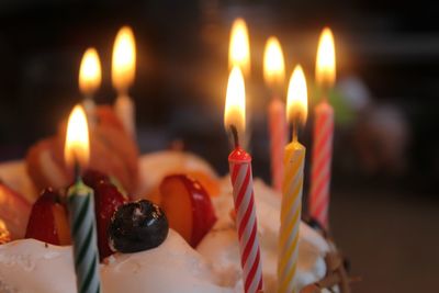 Close-up of burning candles on cake