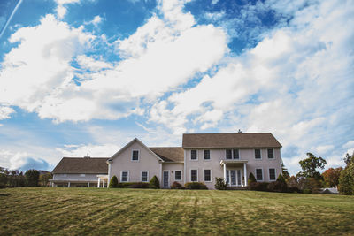 Houses on field against sky