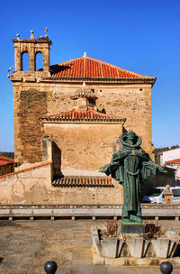 Low angle view of historical building against clear blue sky