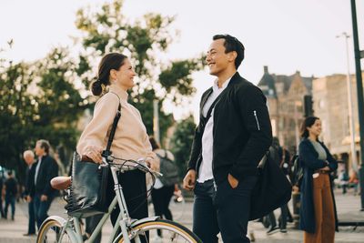 Young man riding bicycle on street in city