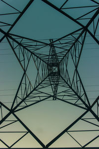 Low angle view of electricity pylon against sky