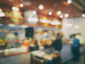 Defocused image of illuminated lights at store