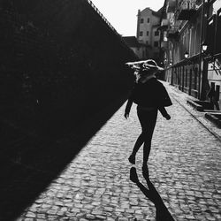 Full length of person with shadow on street