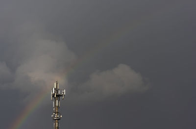 Low angle view of communications tower against sky