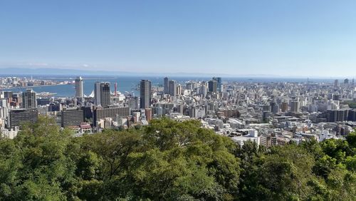 Aerial view of city buildings against clear sky