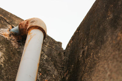 Low angle view of old wall against sky