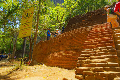 People working on stone wall